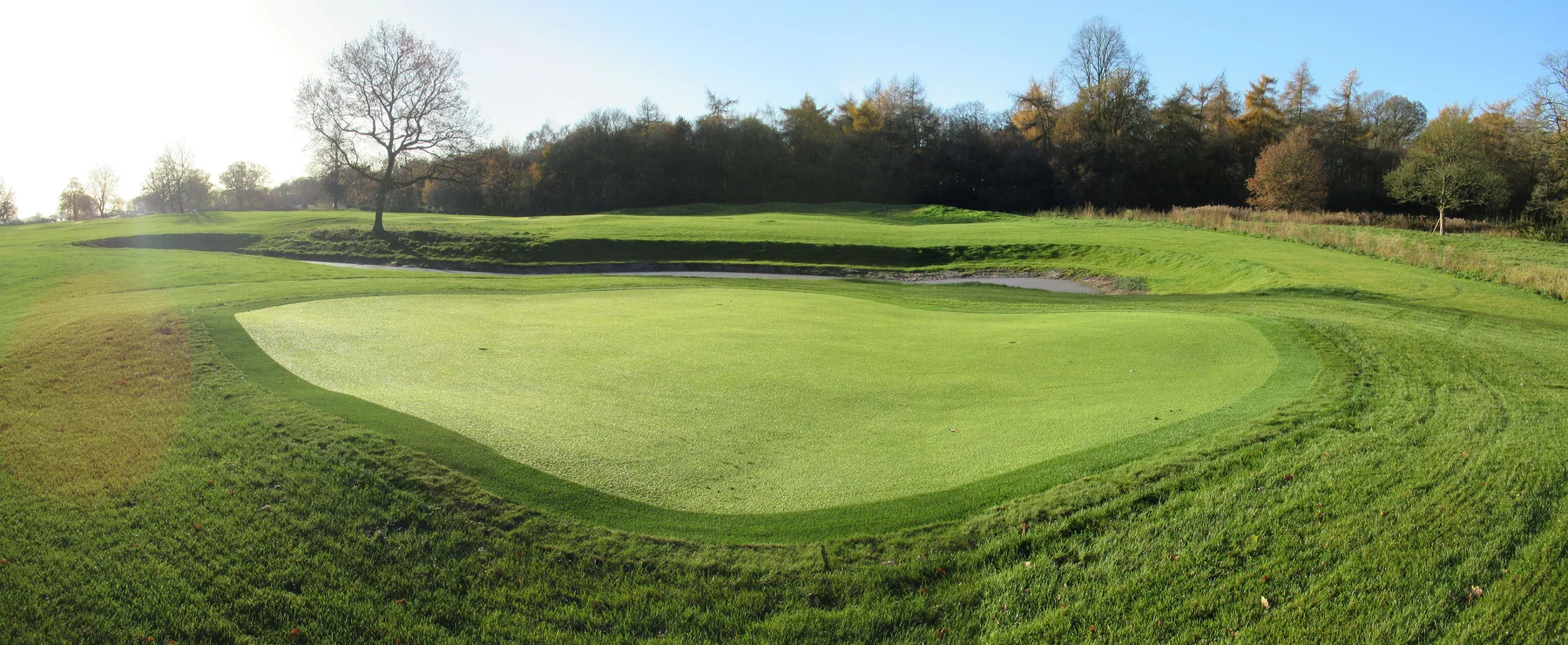Panorama of an artificial turf putting green on a golf course