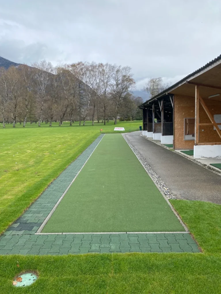 Artificial turf tee line with mountains in the background